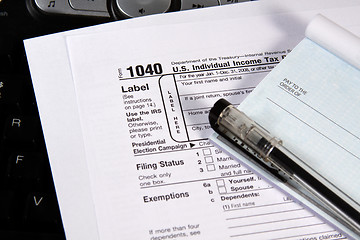 Image showing Preparing Taxes - Check and Forms on Keyboard