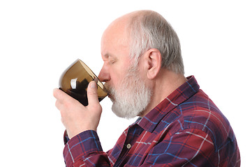 Image showing senior man drinking from cup, isolated on white