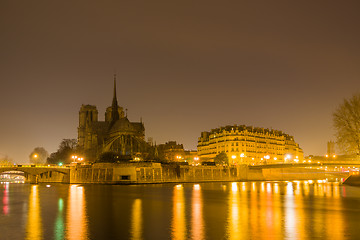 Image showing Notre Dame Cathedral with Paris cityscape at dusk