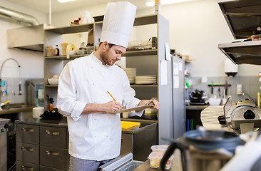 Image showing chef with clipboard doing inventory at kitchen