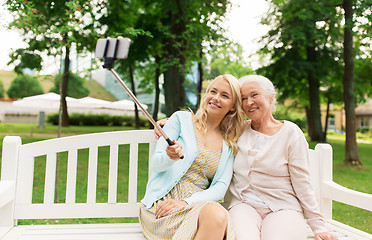 Image showing daughter and senior mother taking selfie at park