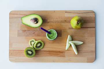 Image showing jar with fruit puree or baby food on wooden board