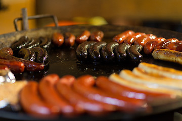 Image showing sausages and salmon frying in stir fry pan