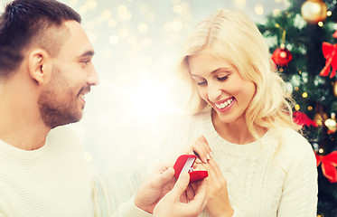 Image showing man giving woman engagement ring for christmas