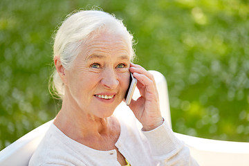 Image showing happy senior woman calling on smartphone in summer