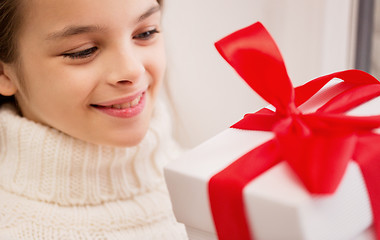 Image showing happy beautiful girl with christmas gift at home