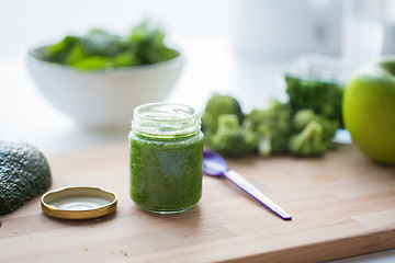 Image showing jar with puree or baby food on wooden board