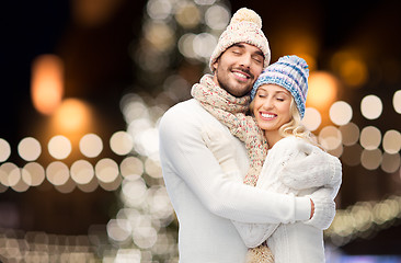 Image showing happy couple hugging over christmas lights