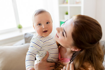 Image showing happy young mother with little baby at home