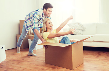 Image showing happy couple having fun with boxes at new home