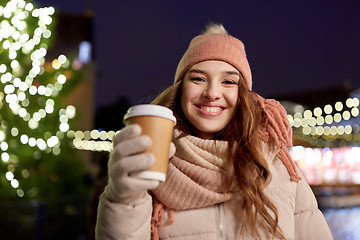 Image showing happy young woman with coffee at christmas market