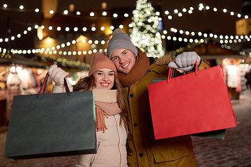 Image showing happy couple at with shopping bags in winter