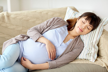 Image showing happy pregnant woman sleeping on sofa at home