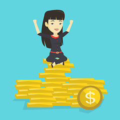 Image showing Happy business woman sitting on golden coins.