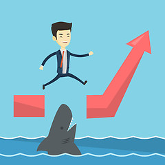 Image showing Business man jumping over ocean with shark.