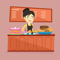 Image showing Worker standing behind the counter at the bakery.