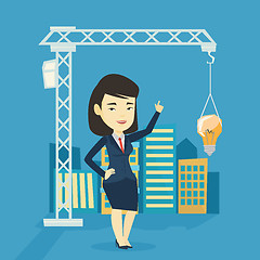 Image showing Woman pointing at idea bulb hanging on crane.