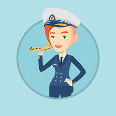 Image showing Cheerful airline pilot with model airplane.