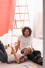 Image showing Happy young couple relaxing after painting