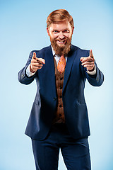 Image showing Portrait of a business man isolated on blue background.