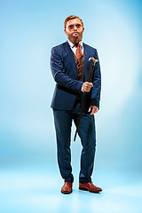 Image showing The barded man in a suit holding cane.