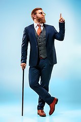 Image showing The barded man in a suit holding cane.