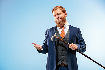 Image showing The barded man in a suit holding cane.