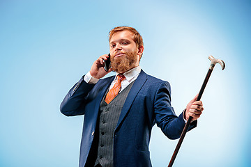 Image showing The barded man in a suit holding cane.