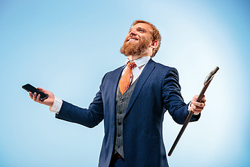 Image showing The barded man in a suit holding cane.