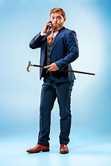 Image showing The barded man in a suit holding cane.