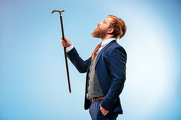 Image showing The barded man in a suit holding cane.