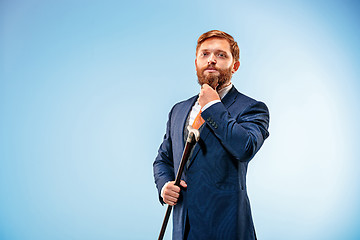 Image showing The barded man in a suit holding cane.