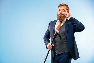 Image showing The barded man in a suit holding cane.