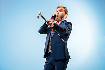 Image showing The barded man in a suit holding cane.