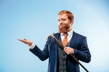 Image showing The barded man in a suit holding cane.