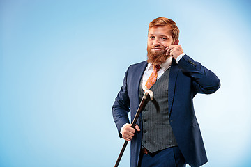 Image showing The barded man in a suit holding cane.