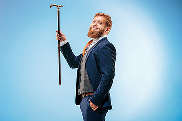 Image showing The barded man in a suit holding cane.