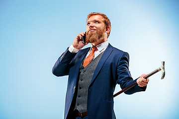 Image showing The barded man in a suit holding cane.