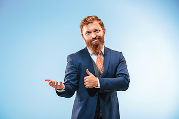 Image showing Portrait of a business man isolated on blue background.