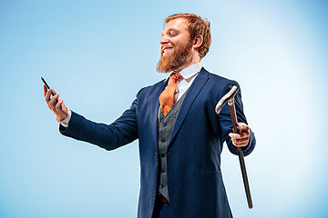 Image showing The barded man in a suit holding cane.