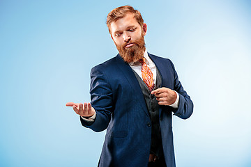 Image showing Portrait of a business man isolated on blue background.