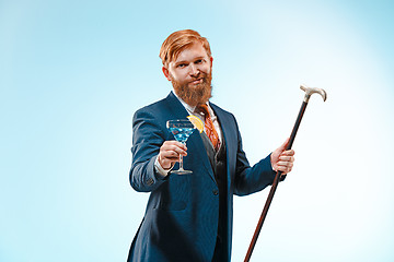 Image showing The barded man in a suit holding cane.