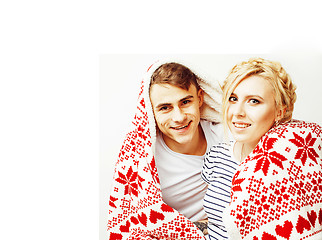 Image showing young pretty teenage couple at Christmas time warming in red dec