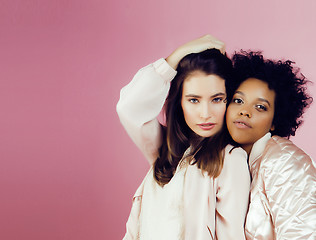 Image showing different nation girls with diversuty in skin, hair. Asian, scandinavian, african american cheerful emotional posing on pink background, woman day celebration, lifestyle people concept 