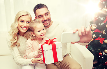 Image showing family taking selfie with smartphone at christmas