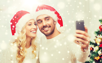 Image showing couple taking selfie with smartphone at christmas