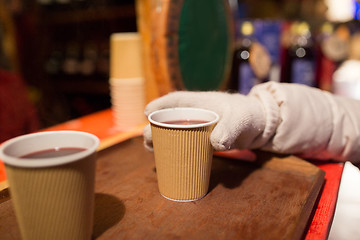 Image showing hand with cup of mulled wine at christmas market