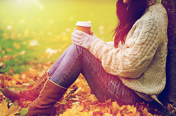 Image showing close up of woman drinking coffee in autumn park