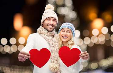 Image showing couple with red hearts over christmas lights