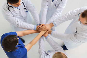 Image showing group of doctors with hands together at hospital